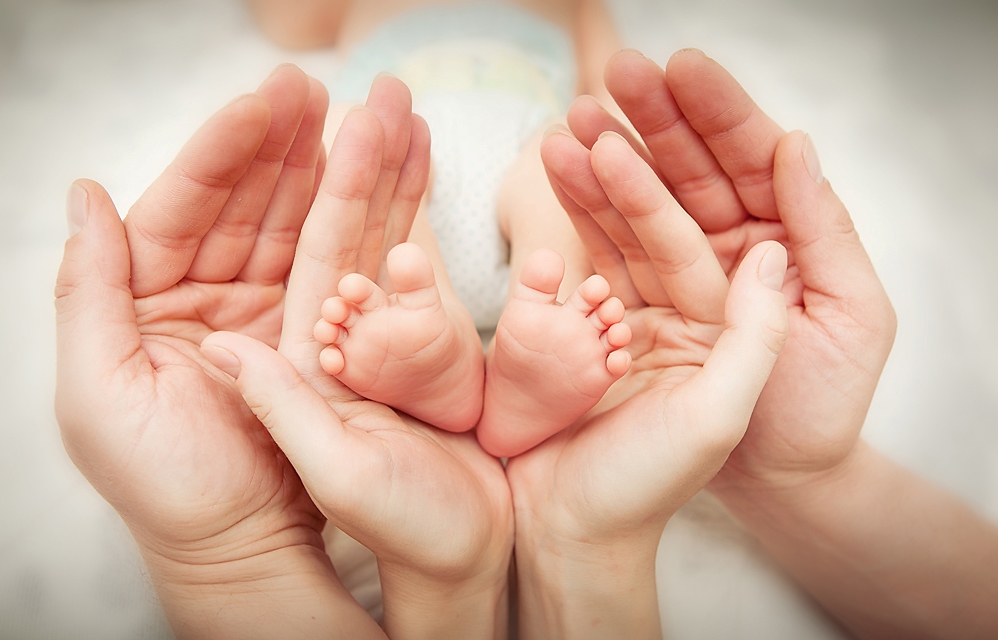 newborn baby's heels and hands